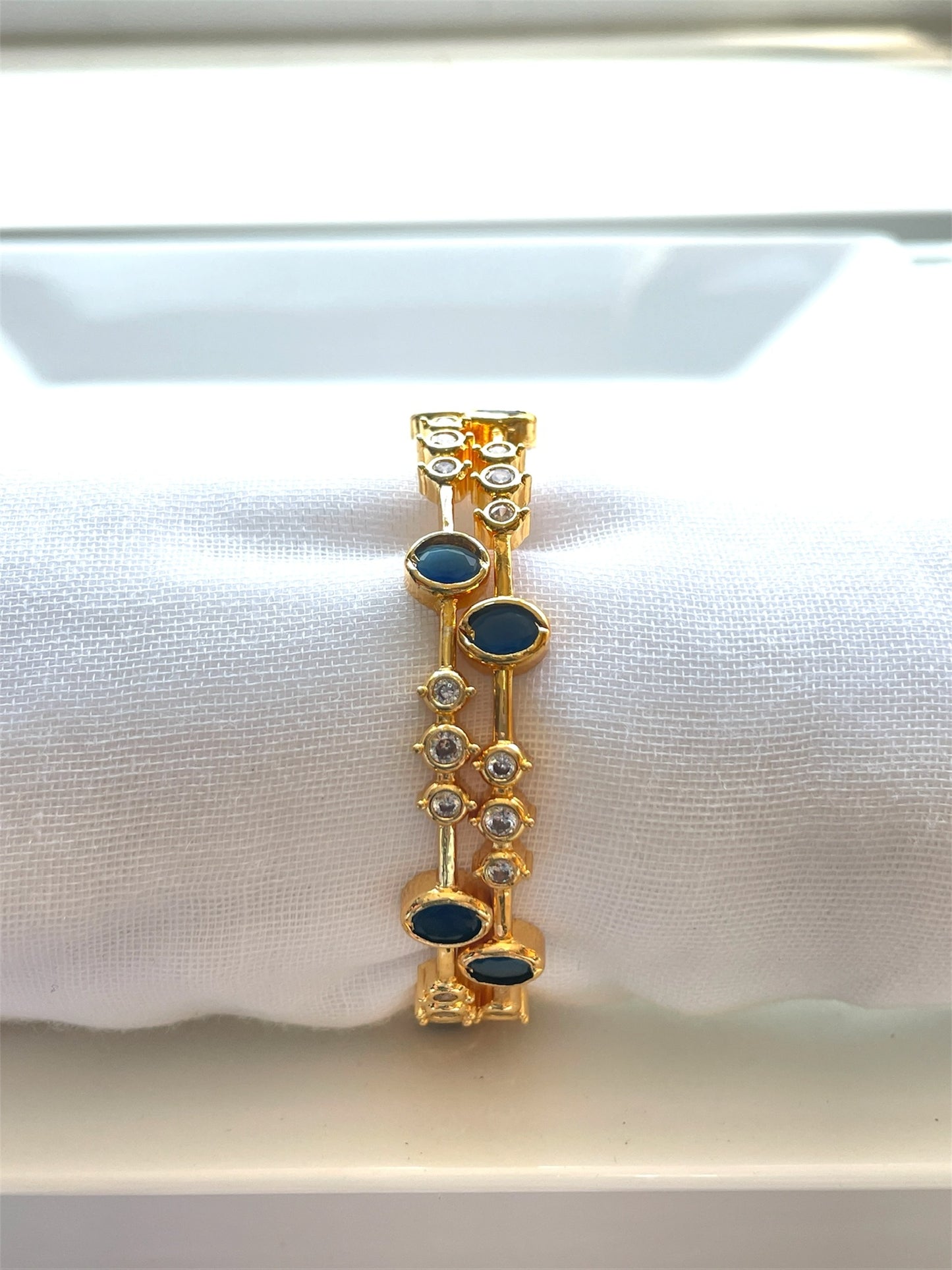 Elegant White Bangle with Blue Stone Accents
