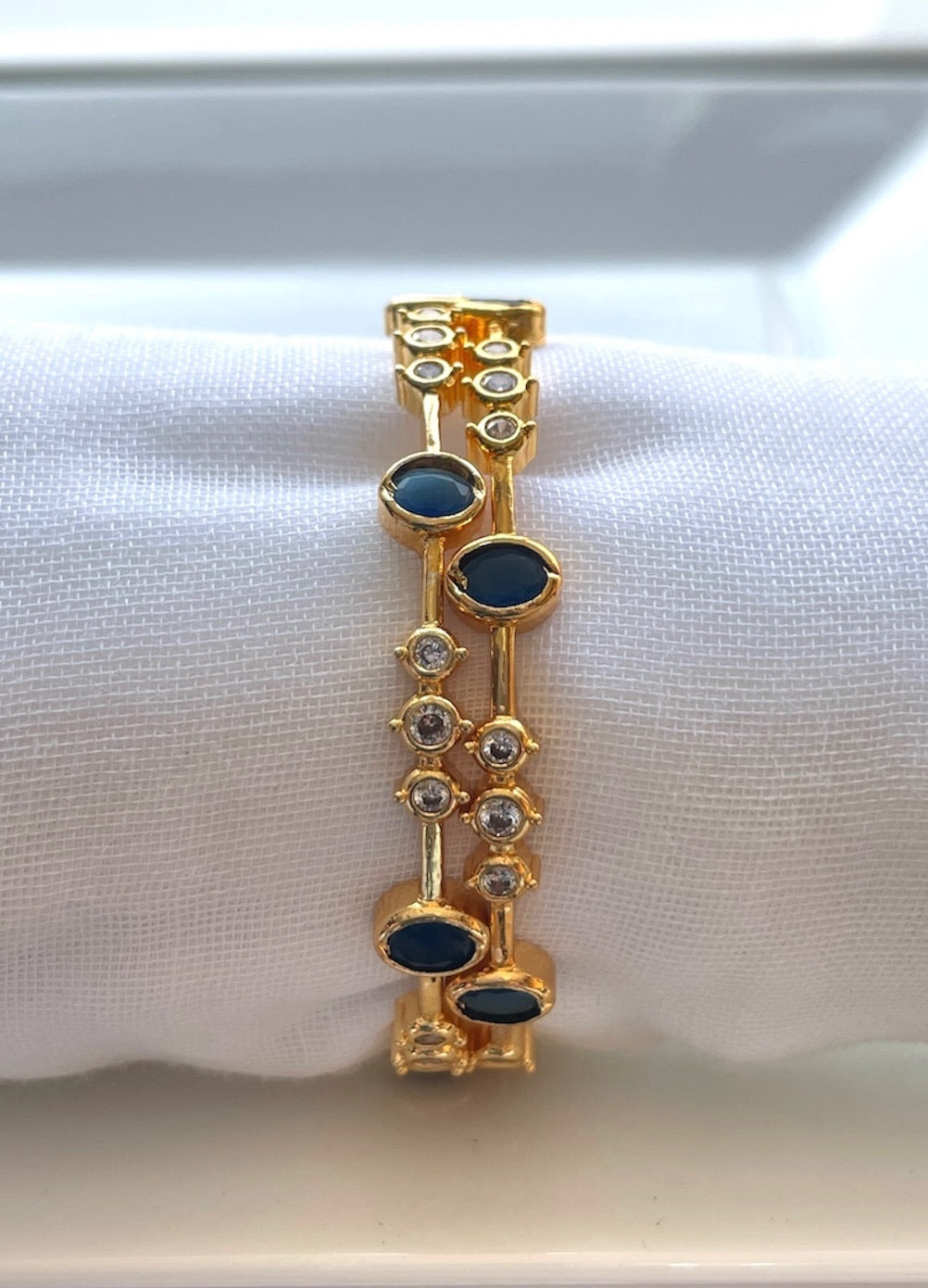 Elegant White Bangle with Blue Stone Accents